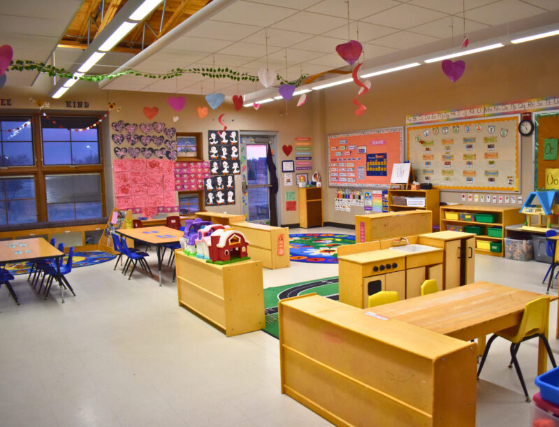 KidsPoint classroom with bright classroom space, toys, tables and chairs, and large window.