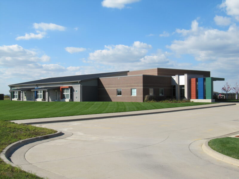 Exterior of KidsPoint C Street building with winding road leading up to it.
